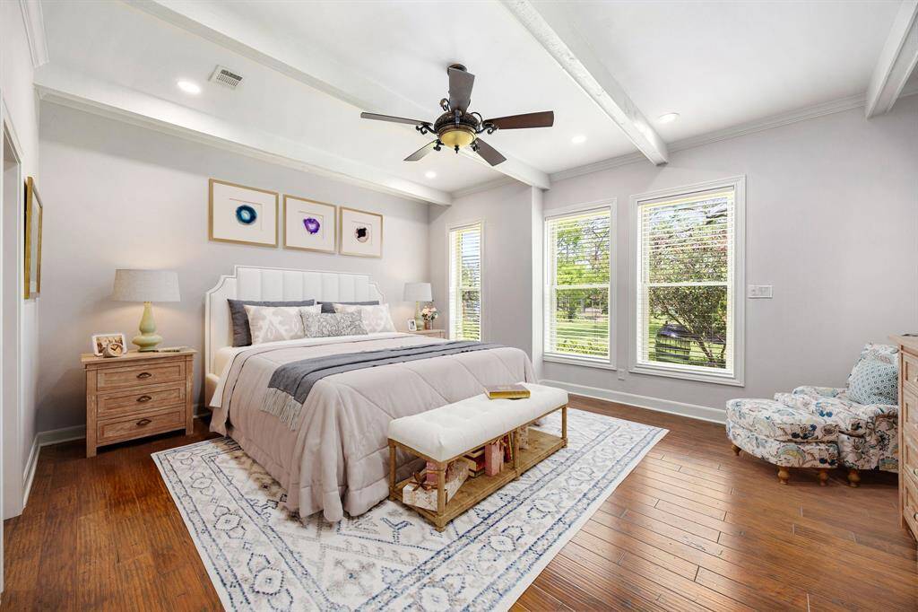 What a wonderful place to come home to, this stunning primary suite greets you with gorgeous wood style floors, a warm custom paint, high ceiling, crown molding, ceiling fan with lighting, lovely windows with custom blinds allowing in natural light brightening up this spacious primary bedroom, with extra space for a seating area. *Virtually Staged