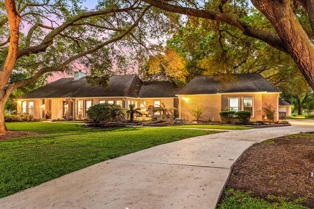 Welcome to 1410 Foster Meadow Dr., a beautifully maintained home tucked away on a peaceful street in Foster Creek Estates and zoned to Lamar Consolidated ISD. Situated on a sprawling 2.94-acre lot, this property offers stunning curb appeal, immaculate landscaping, a private swimming pool, a charming guest house, and a long driveway perfect for extra parking.