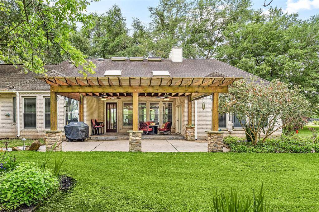 Step into your private outdoor oasis! This spacious backyard features a charming covered patio, a paved side walkway, and ample room for kids to play or adults to unwind. Whether you're hosting a BBQ, setting up patio furniture, or simply relaxing under the shade this space is ready for it all. Endless possibilities await!