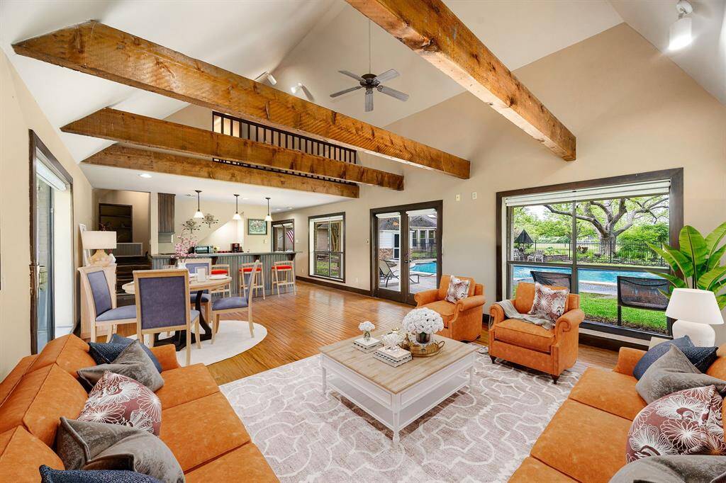 This cozy guest house living room offers timeless character with wood-beamed ceilings, natural light, and versatile space for relaxing or hosting. *Virtually Staged