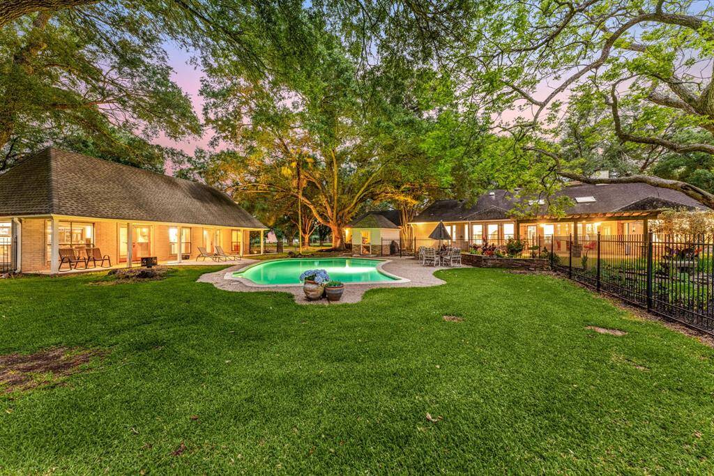 This spacious backyard is built for fun and relaxation boasting a beautiful pool, open green space, and room for kids to play or guests to gather. A true entertainer’s dream!