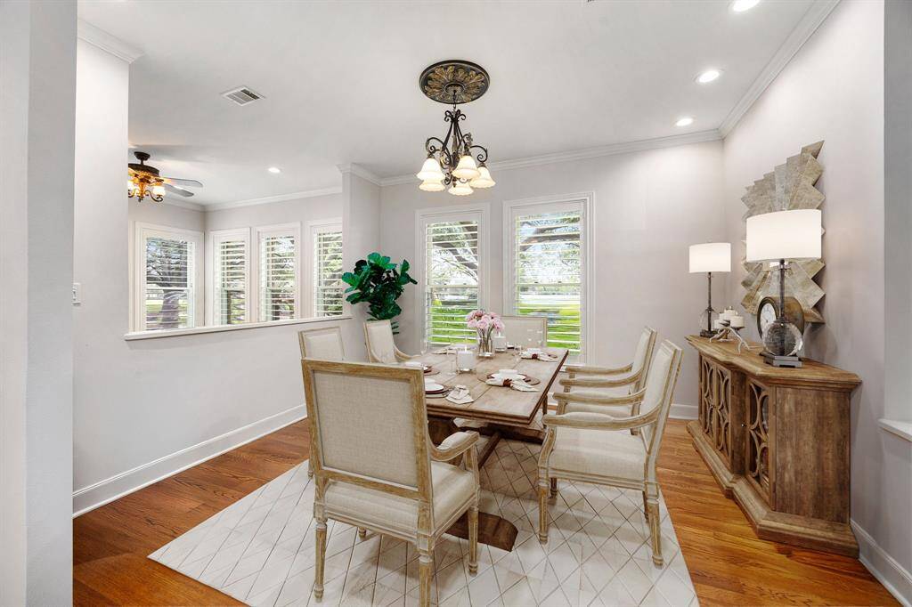 You and your guests will certainly dine in style in this amazing formal dining room! Featuring a gorgeous  chandelier, large window with shutters, neutral paint, high ceilings, crown molding, and wood style floors. Perfect space to entertain family and friends. *Virtually Staged