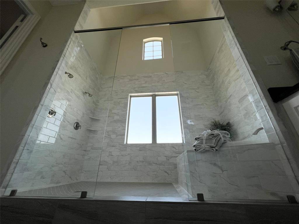 Tub and shower behind glass walls
