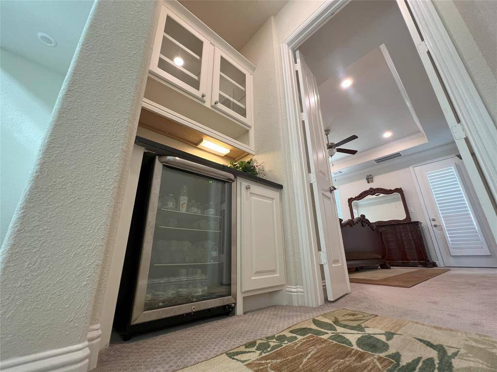 Ask your hubby to grab a cold drink, wine cooler is right outside primary suite
