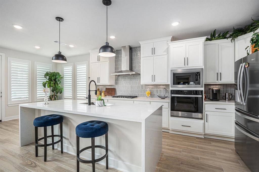 Kitchen island offers plenty of counter space to cook as well as a breakfast bar.
