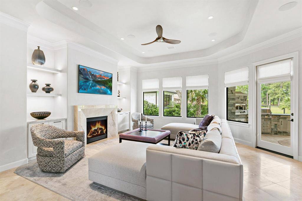 The family room is designed for comfort and beauty. So much natural light with the wall of windows and door to the patio.