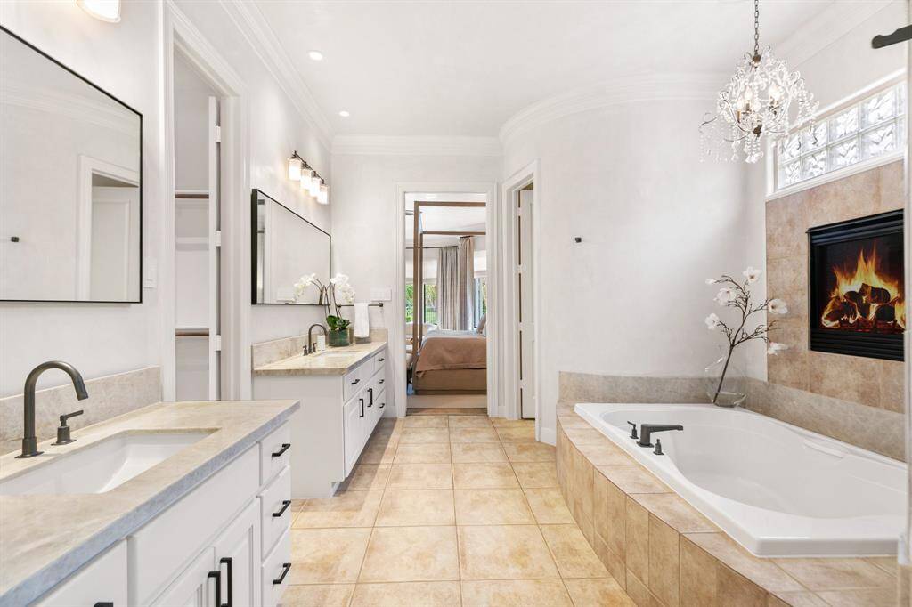 Gorgeous Taj Mahal Quartzite counters on the double vanities and contemporary light fixtures and mirrors.