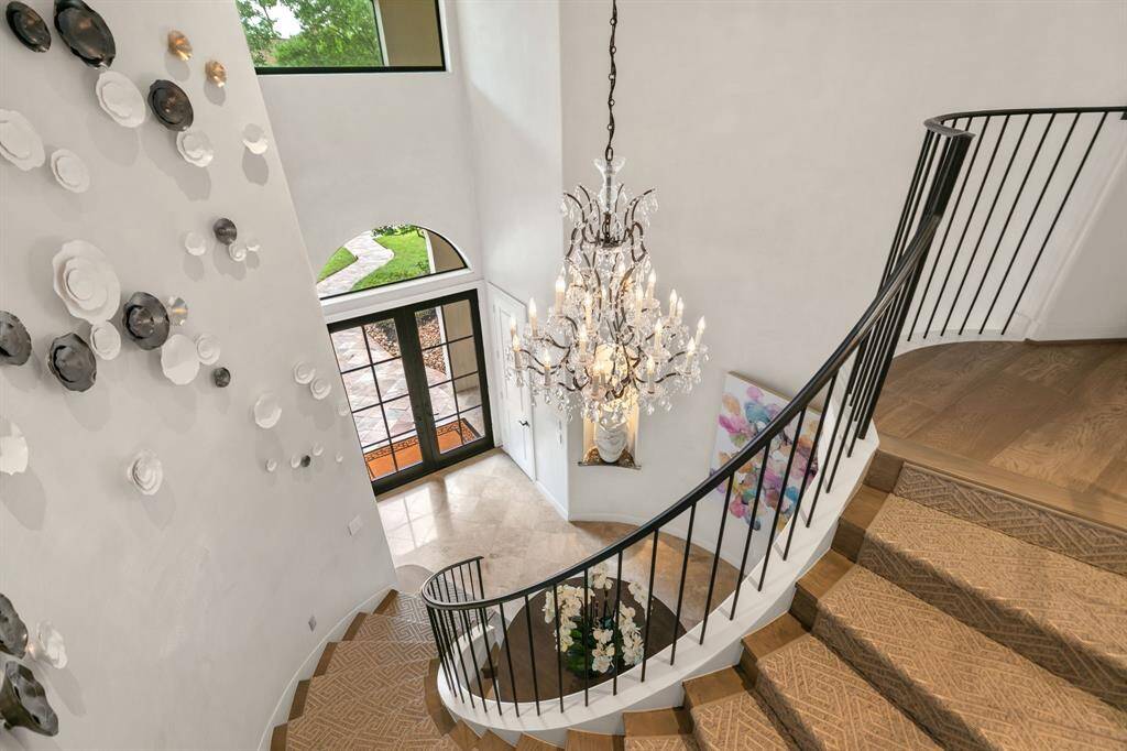 Such a dramatic staircase and crystal chandelier!