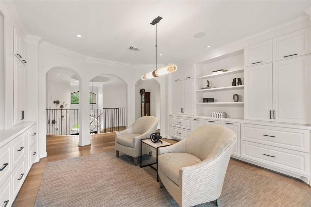 The game room is located at the top of the stairs and has plenty of space for games and movies. This room is also designed to use as an office with floor plugs and built-in file cabinets.