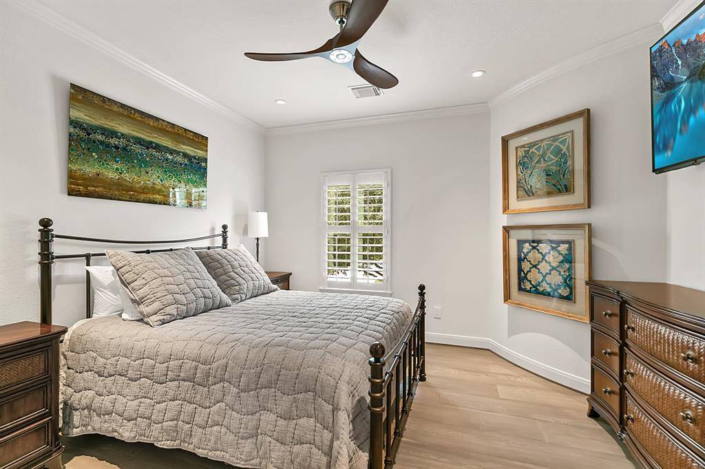 Bedroom 3 features shutters, a ceiling fan and wood floors.  Bedrooms 2 and 3 share a Jack 'N Jill bath.