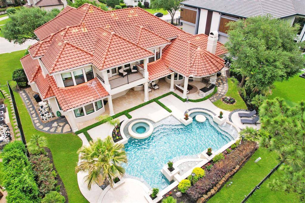 A sparkling pool and spa, extensive decking, covered patios, a balcony and lush landscaping make this a backyard paradise!