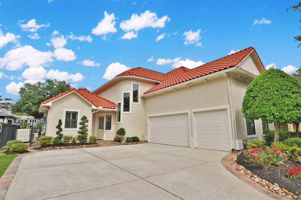 The side-by-side 3-car garage features epoxy floors and storage cabinets.