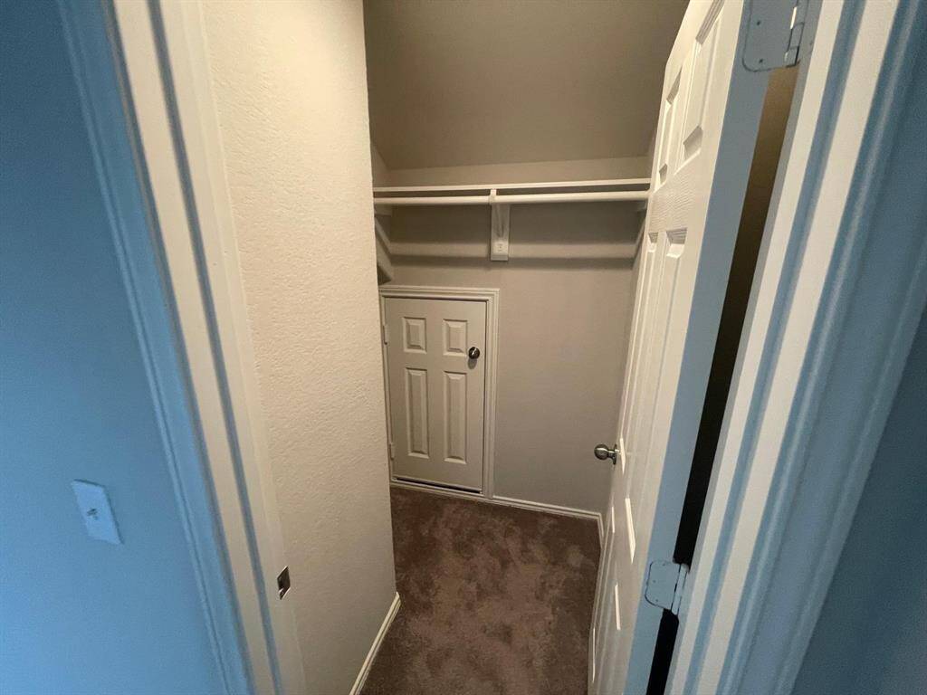 Closet of the 4th bedroom with the attic door tucked in the closet!