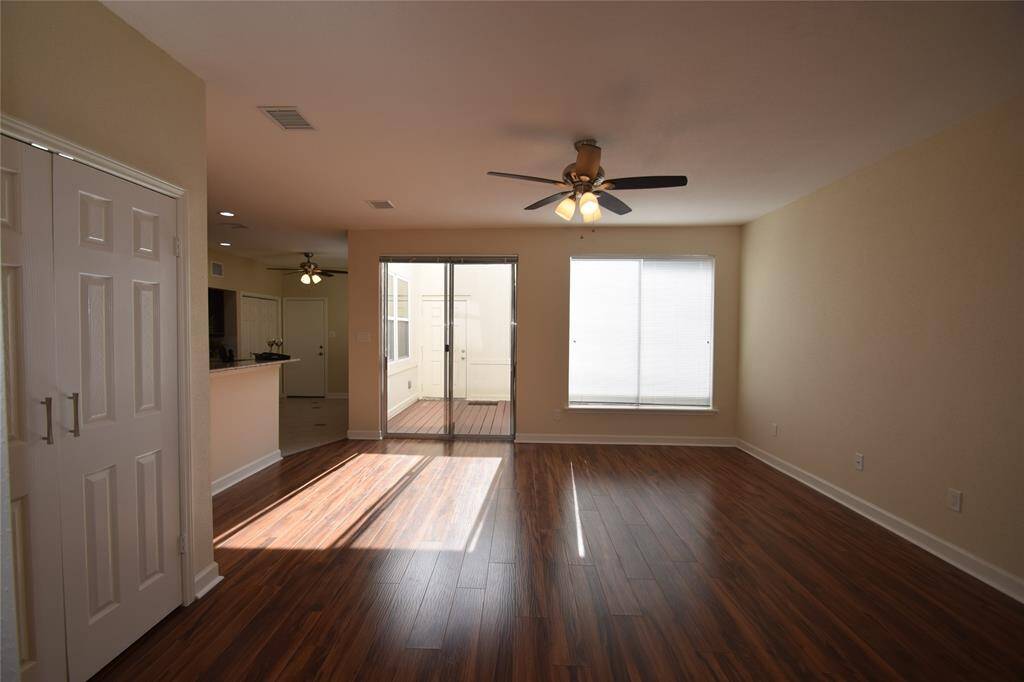 Family room offering a glass sliding door opening to the atrium style patio area.