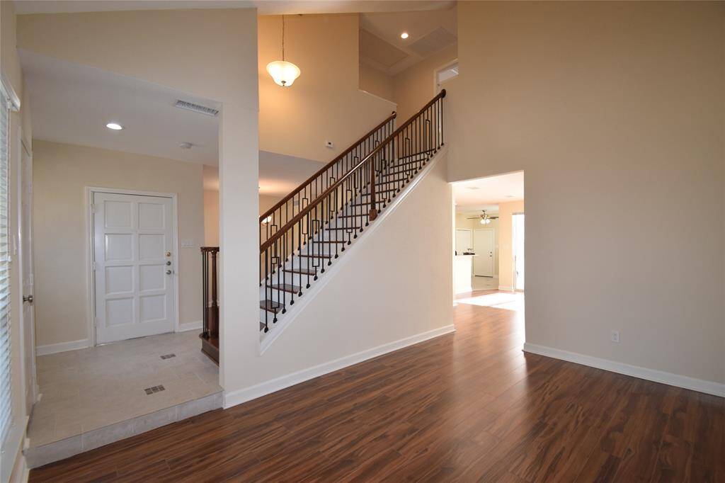 View from the living room or study opening to the entry and stairway.