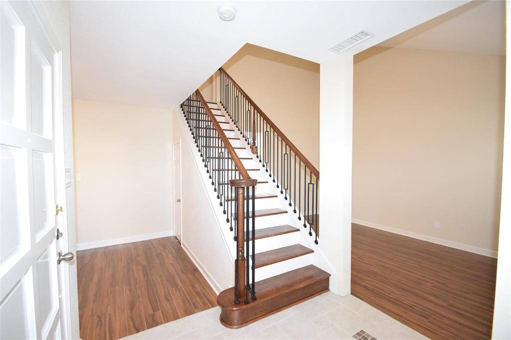 Entry offering a raised tile floor entry and access to the stunning stairway.