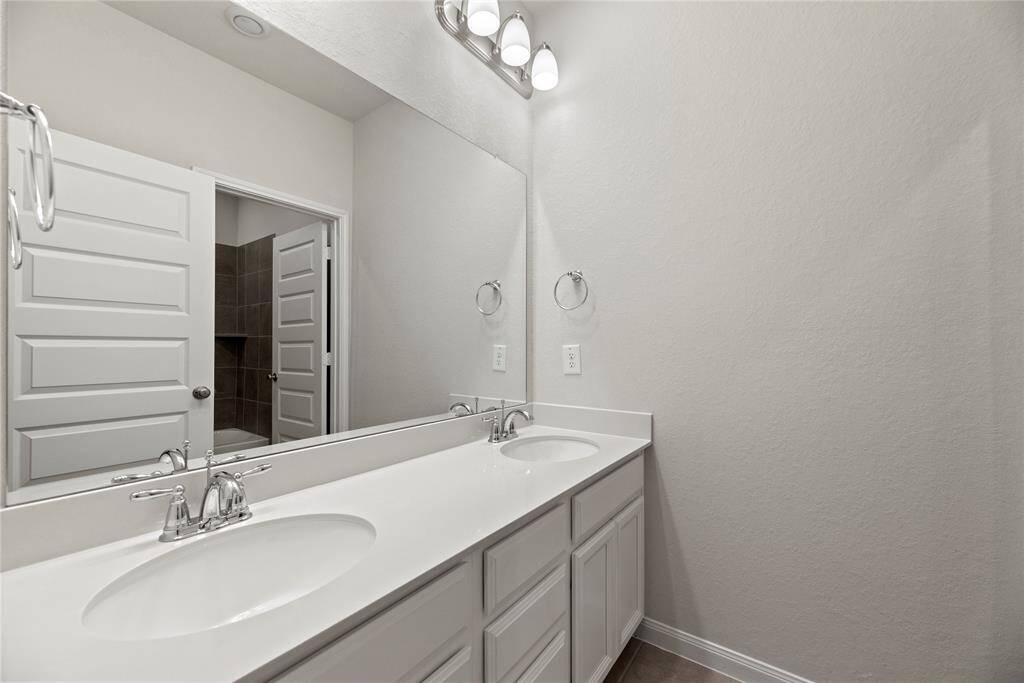 The primary bathroom on the second floors features a sleek double sink vanity.