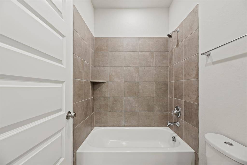The guest bathroom on the second floor features a tub/shower combo and neutral colors.