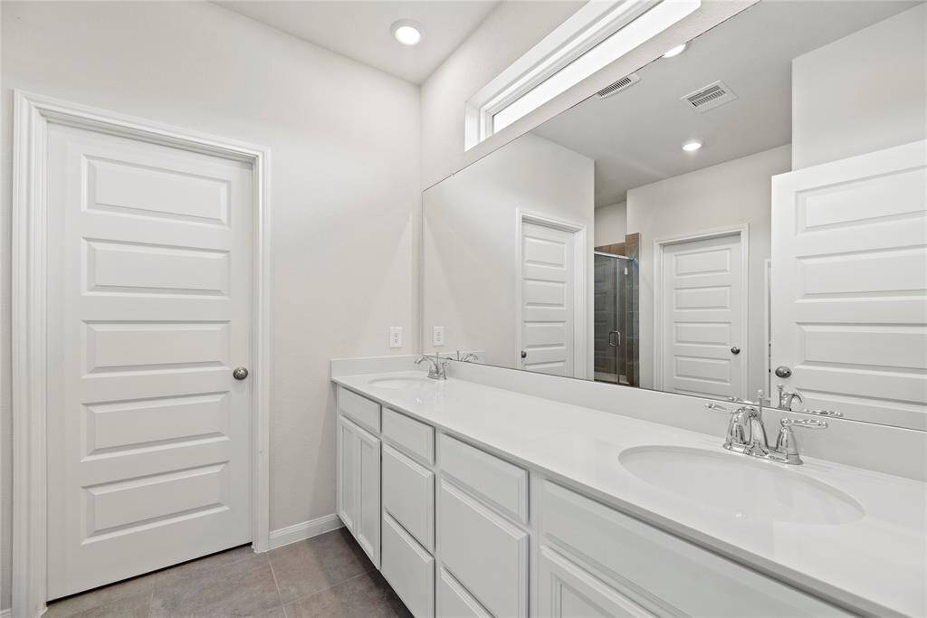 Another view of the bright and sleek primary bathroom.