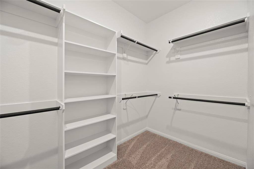 Oversized walk-in primary closet.