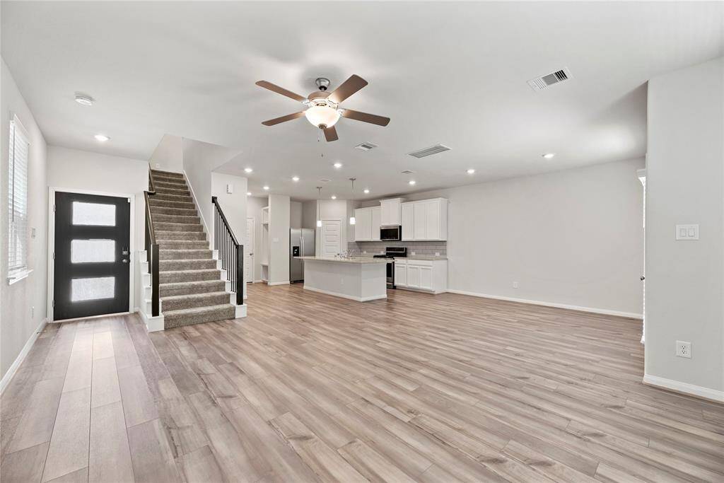View from the family room overlooking the breakfast area, kitchen, and entryway.