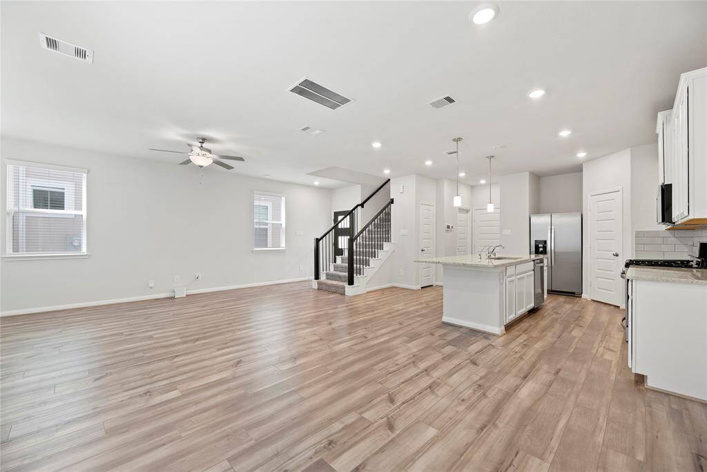 View from the breakfast area overlooking the family room, entryway, and kitchen.