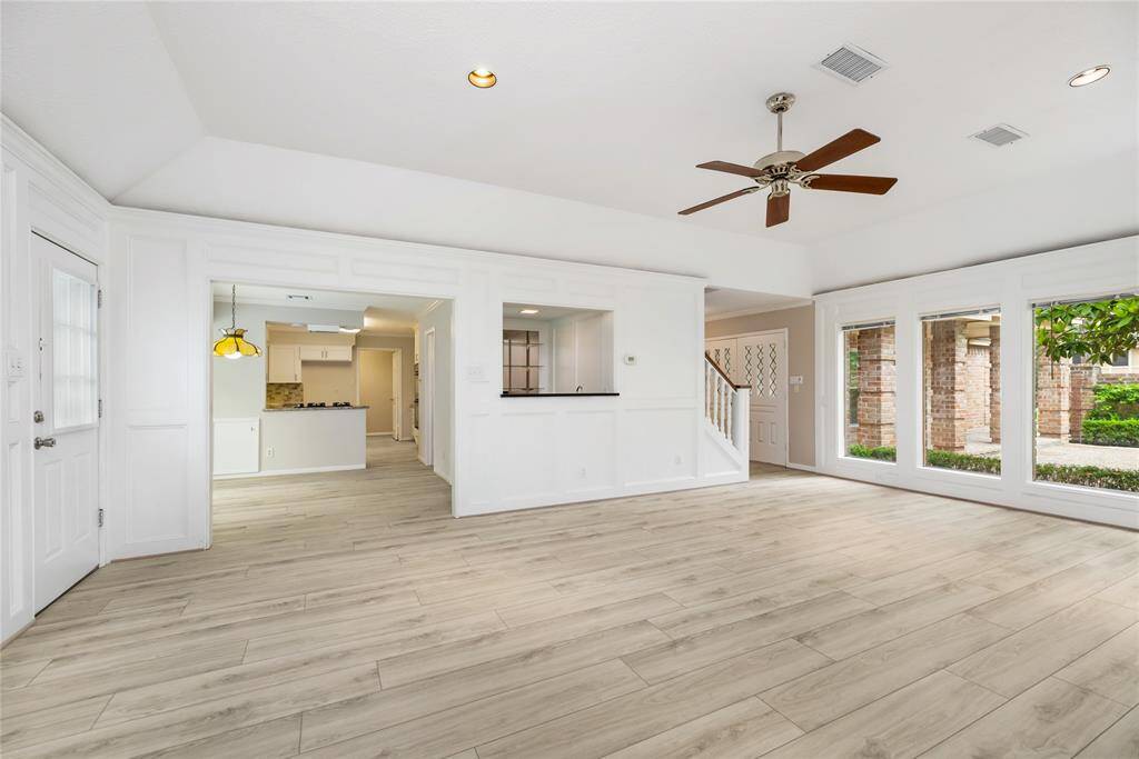 This generous living room provides ample space to grow, entertain, and make lasting memories. Whether you're hosting guests, or simply relaxing by the wood-burning fireplace, it’s the perfect place to live life to the fullest while enjoying views of the backyard oasis.