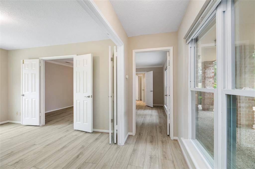 The primary suite offers serene, private views of the front patio, creating a peaceful retreat.