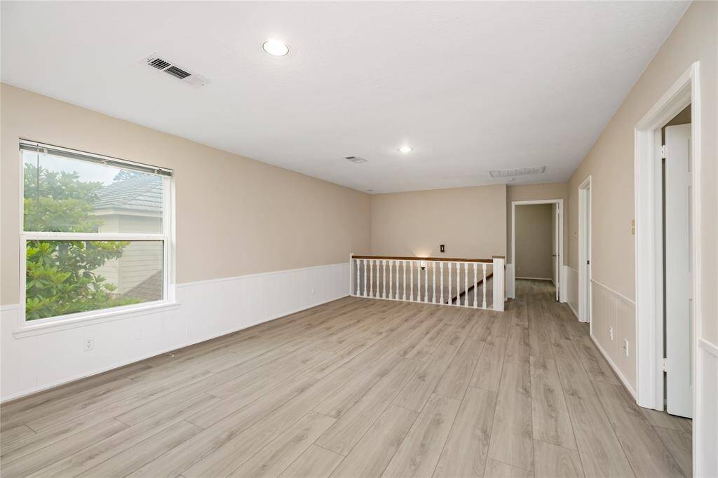 This versatile game room or flex space is conveniently located just off the stairs on the second floor, offering endless possibilities for use—whether as a playroom, home office, or media room.