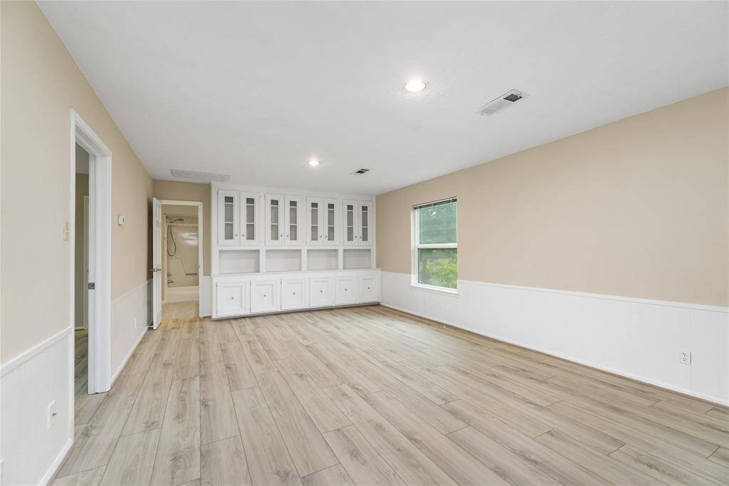 The expansive game room upstairs features beautiful, classic built-ins, offering both style and functionality. A full secondary bathroom is conveniently located just off the room, adding extra comfort and convenience for family and guests.