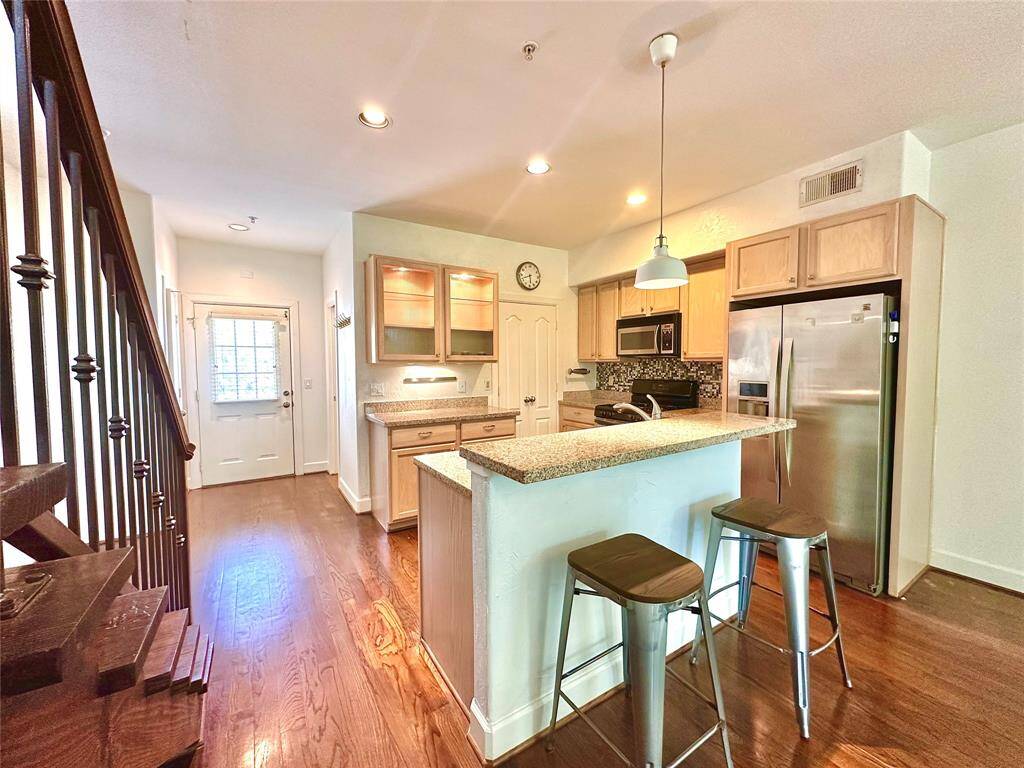 Welcome! Front door seen here brings you into spacious kitchen, dining, living combo area with lots of natural light.