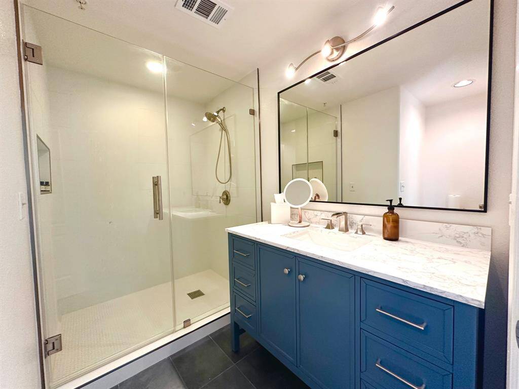 Recently updated and spacious primary bathroom with extra-large walk-in shower. This is the only full bathroom in the unit.