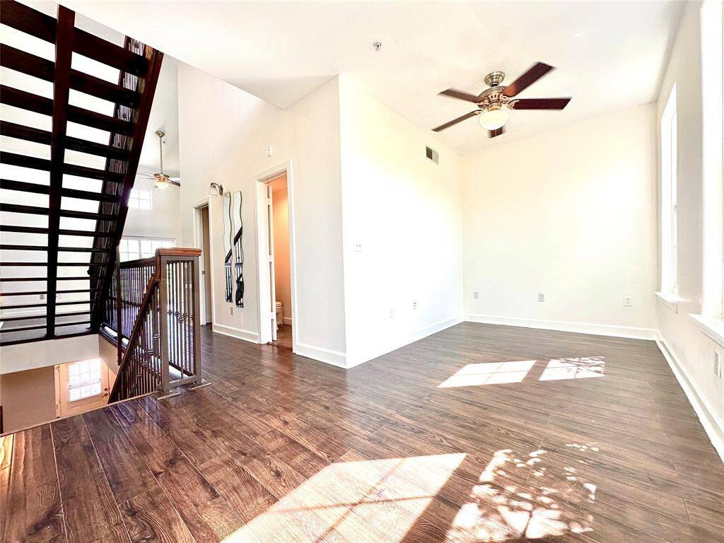 Another view of the space that can be used as a secondary bedroom or study. Room has ceiling fan and lots of natural light. Windows overlook onto Crawford Street.