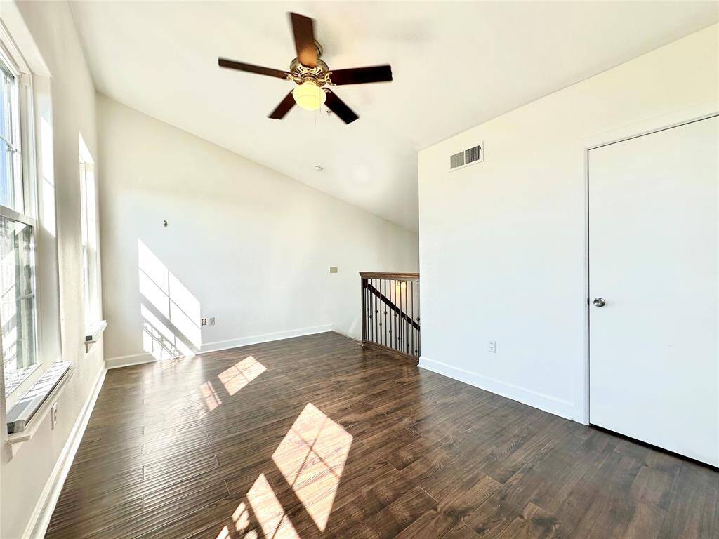 Another view of the third floor of the unit with lots of natural light and ceiling fan.