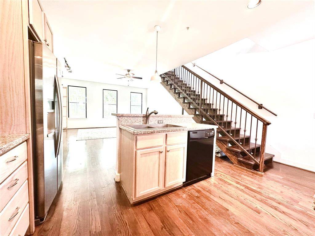 View from the utility room (washer and dryer included) into the kitchen and large living area with lots of natural light.