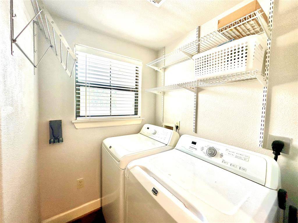 Utility room is next to kitchen and has stainless drying rack and shelves for your convenience. Washer and dryer is included.