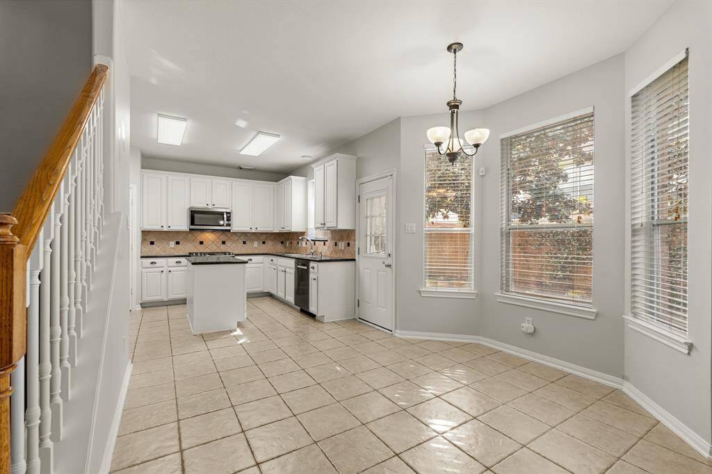 Start your day off right with a cup of coffee sitting with your family in the breakfast area! Featuring a large bay window, neutral paint, a chandelier, and bright natural light!