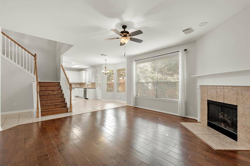 Step into this beautifully designed open-concept home! Featuring a ceiling fan, bright natural light, recessed lighting, and wood floors this living space offers it all. The open concept living room and kitchen makes for a great way to keep the party going and never miss a beat!