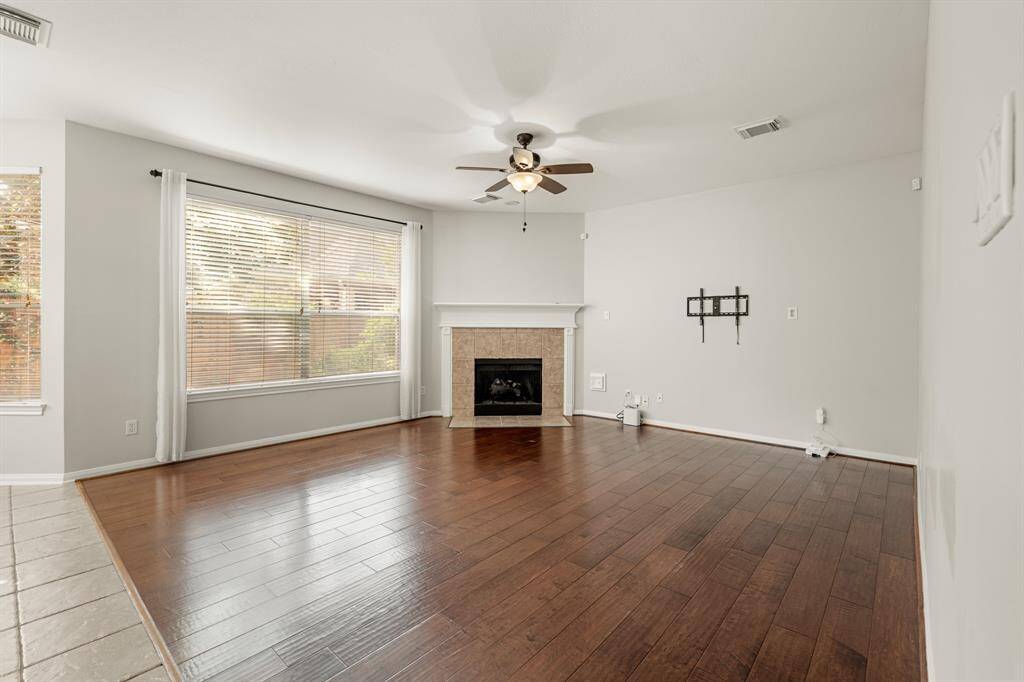 Imagine hosting the next holiday or social event in the perfect living space! You'll love cozying up by the fireplace, complete with a wood mantle and tile surround. This room can fit any size tv making it great for the next big game or movie night.