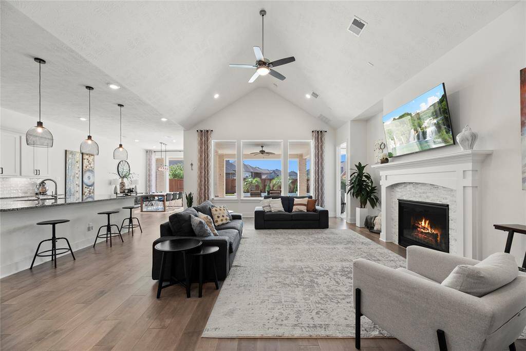 Its open-concept design offers an ideal layout for daily living, highlighted by a generously sized family room with a stunning vaulted ceiling featuring elegant beams.