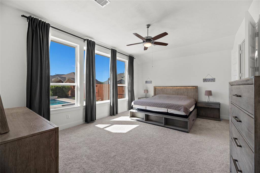 Unwind in the generous primary suite featuring a freestanding tub, an expansive walk-in closet, and dual vanities.