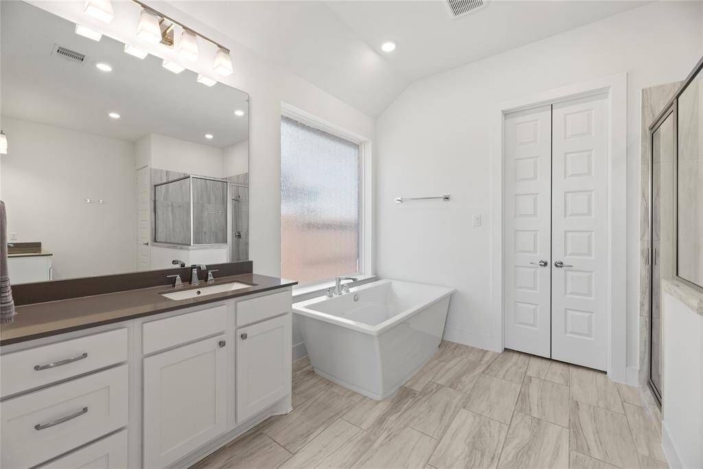 Primary bath with double sinks, soaking tub and separate shower.