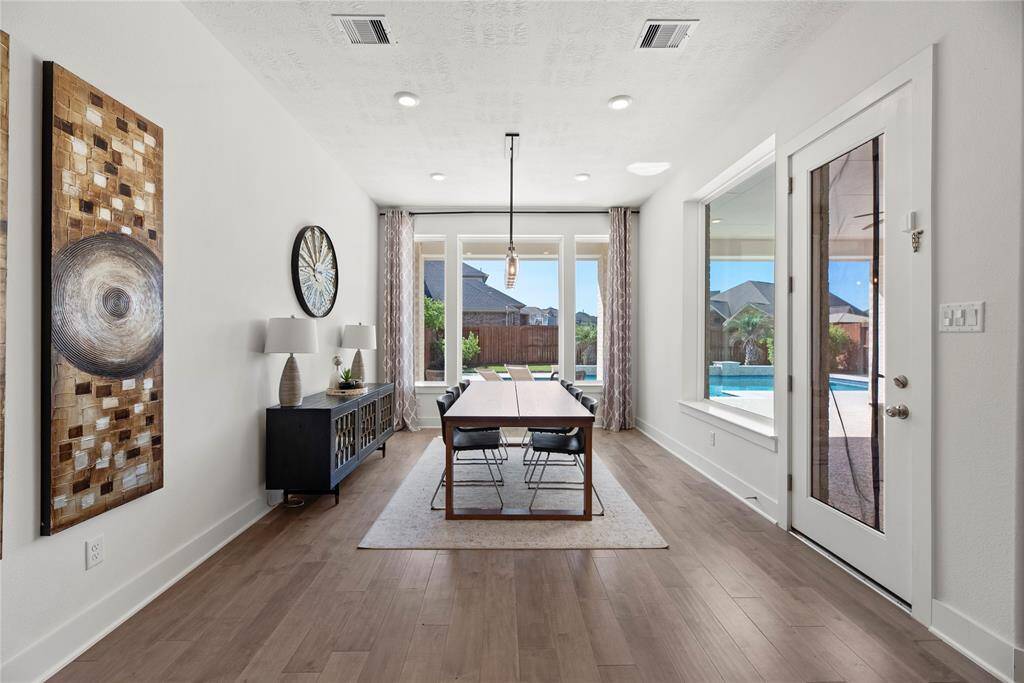 Formal dining area with beautiful views of pool and backyard.