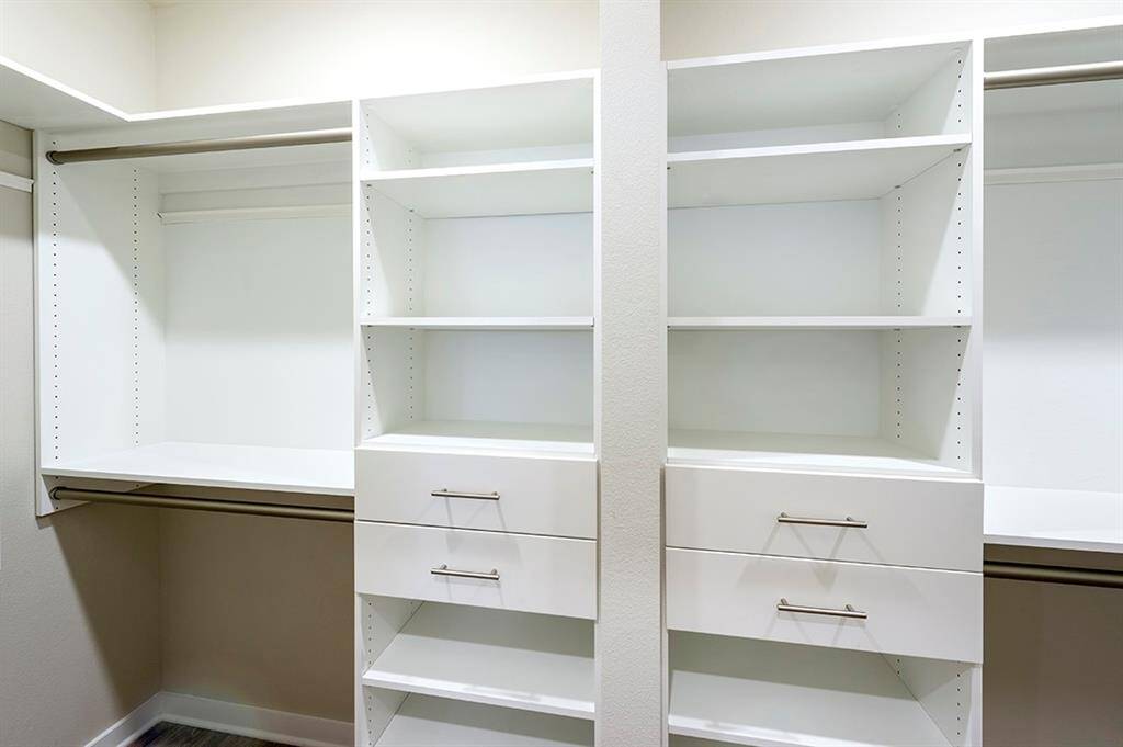 Primary closet with built-in drawers and shelves