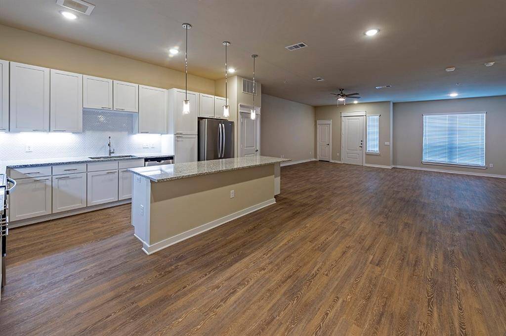 Spacious living and island kitchen with built-in wine rack