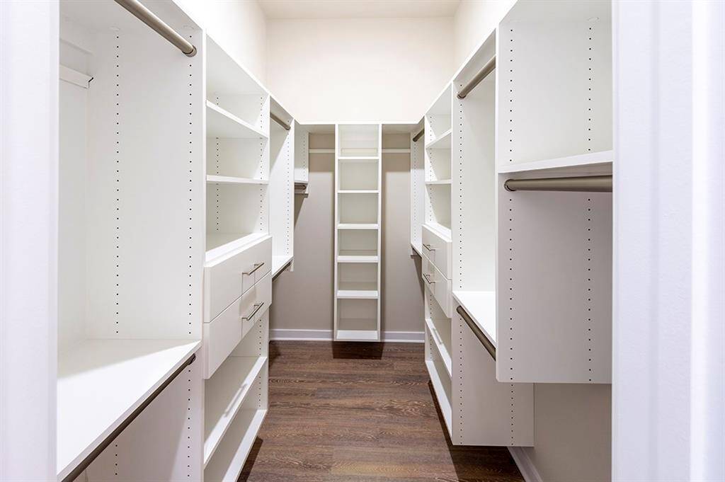 Primary closet with built-in drawers and shelving