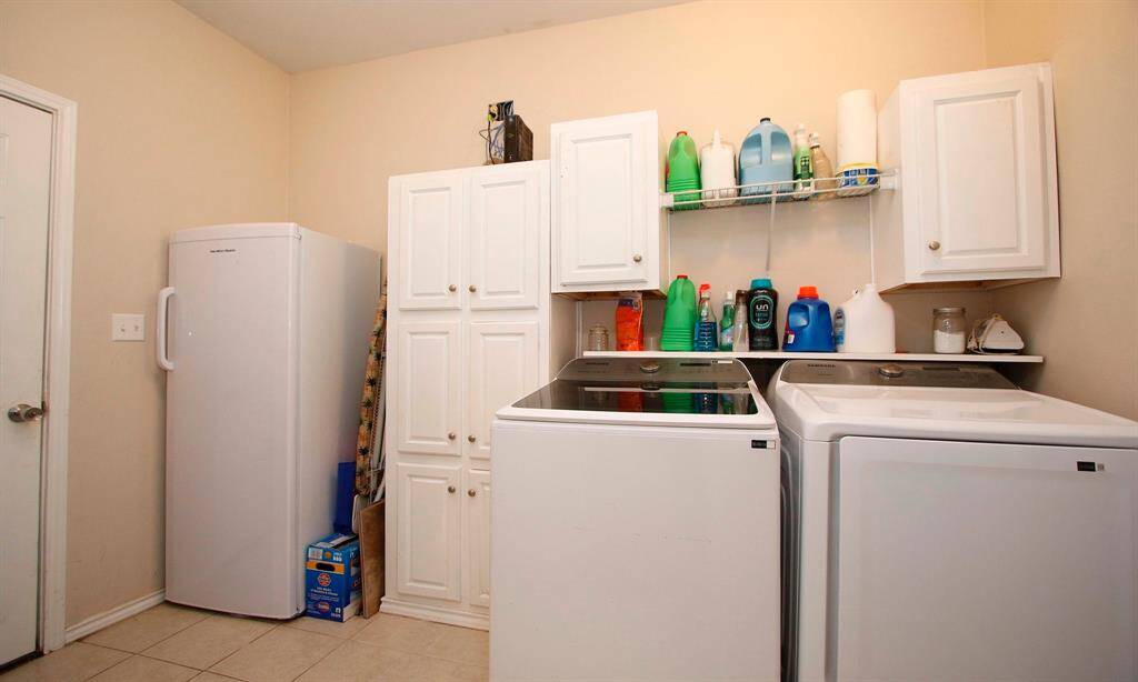 Laundry room with storage and space for another fridge or freezer