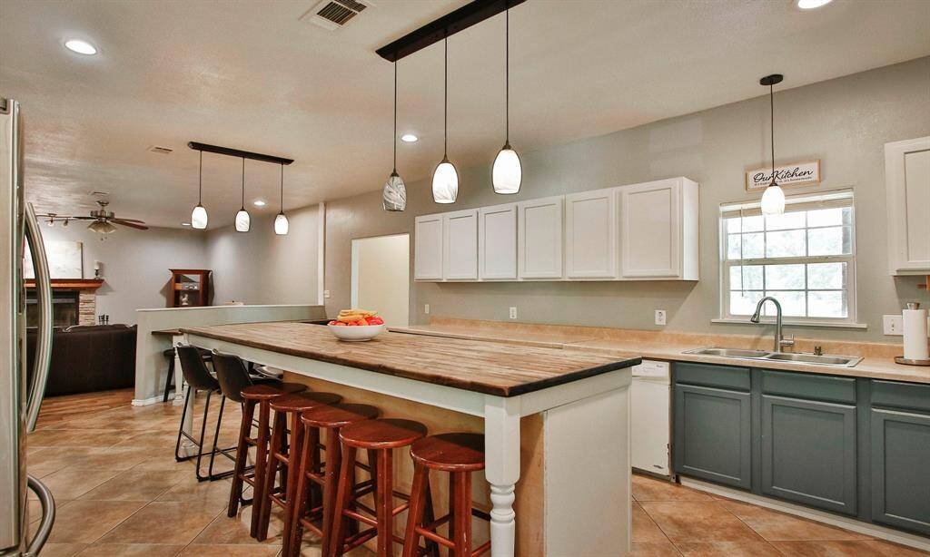 From the Living room you enter a beautiful Kitchen with an 8 ft island and seating for 9.