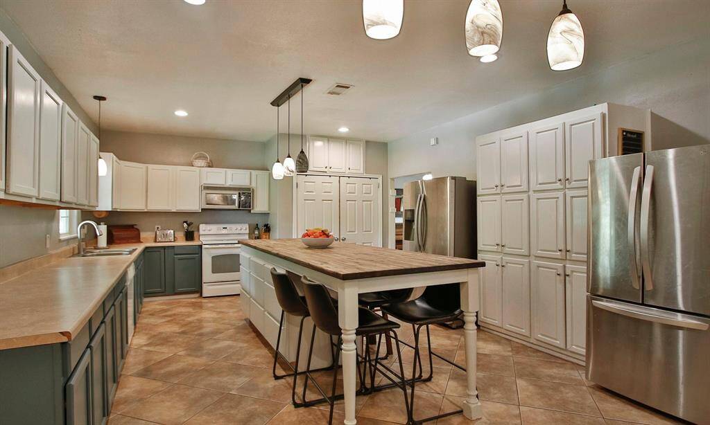 Plenty of cabinets and counter space in this Kitchen.