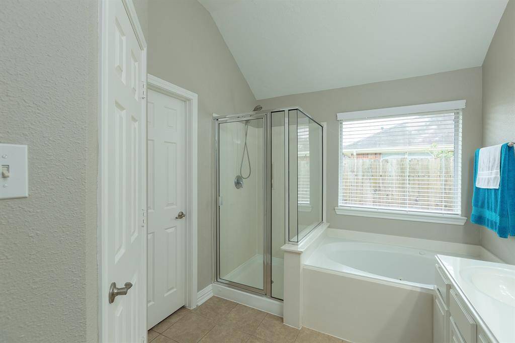 Master bath with double sinks, and separate shower and tub